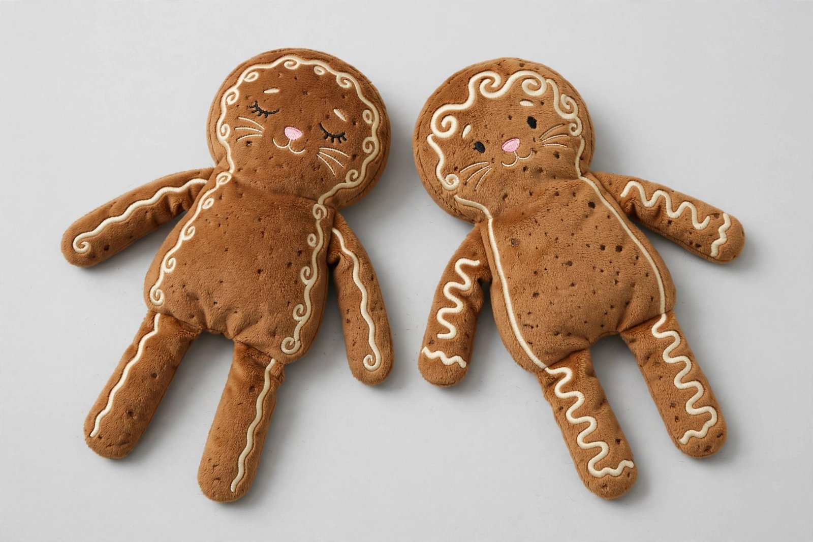 Two plush gingerbread-man cat kicker toys with catnip