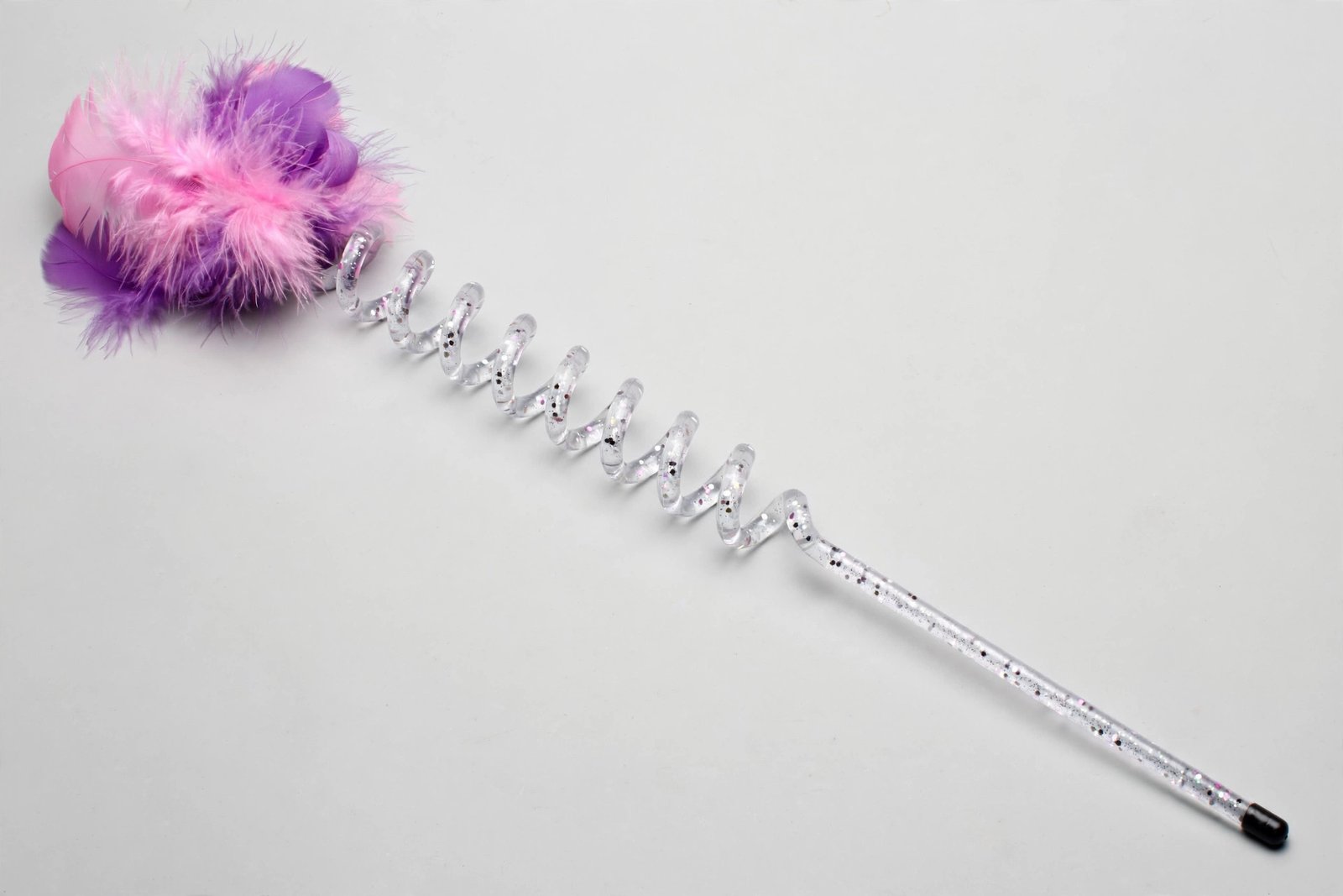 KONG Teaser Curlz cat toy with a clear glittery wand, corkscrew curl and boa feather target