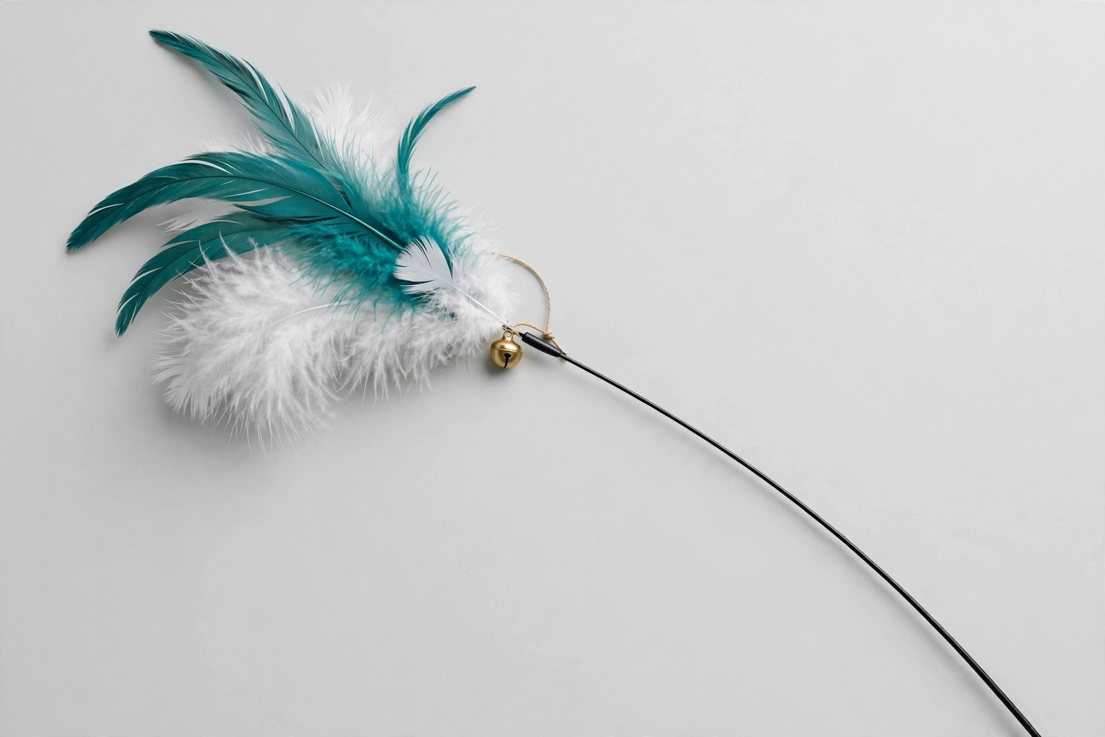 Cat teaser wand with a big puff of wispy white and teal feathers and a small bell