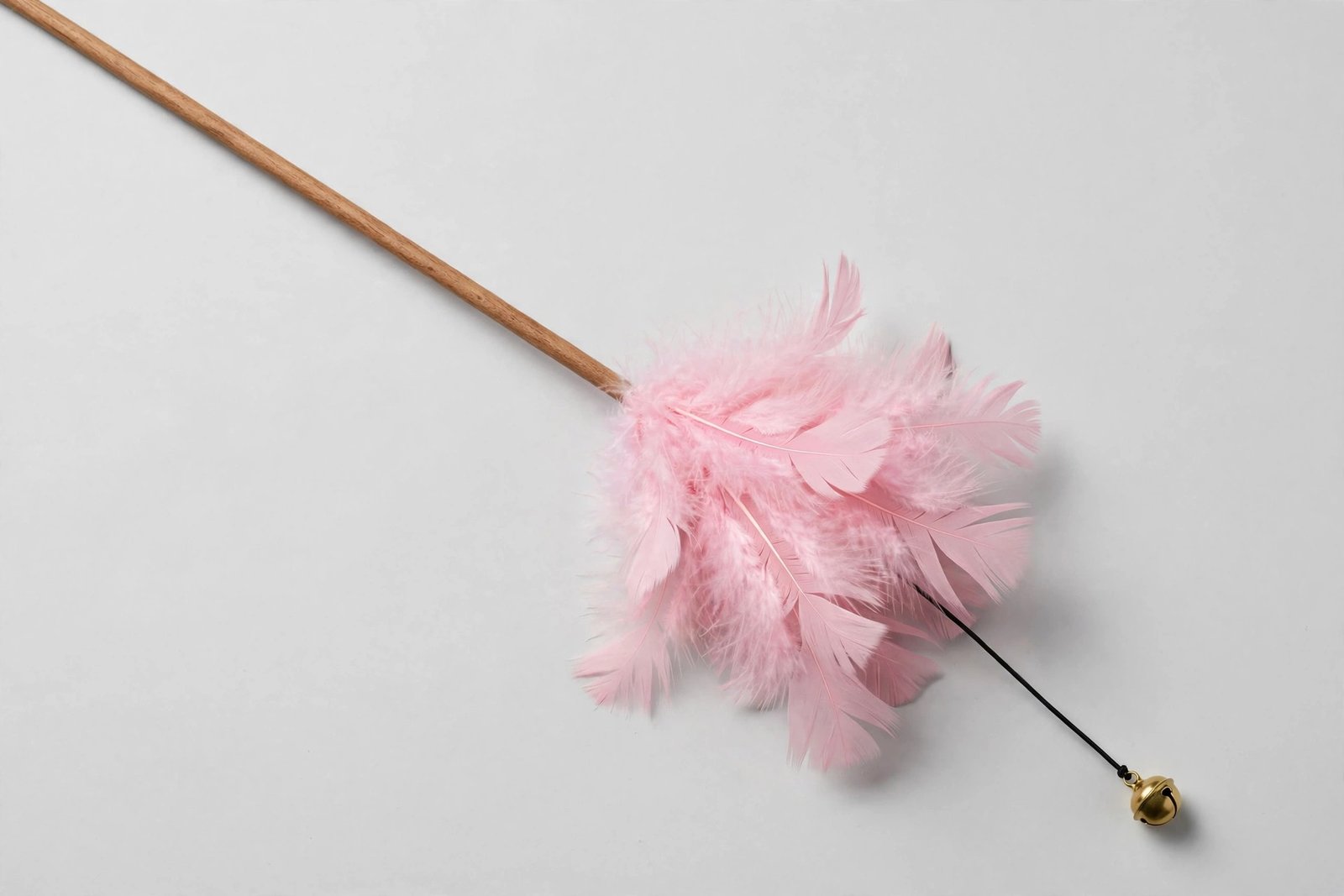 Cat teaser wand with a full cluster of soft pink turkey feathers and a small bell